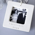 White photo ornament with a black and white photo of a couple and 'Christmas 2026' text on a gray background.